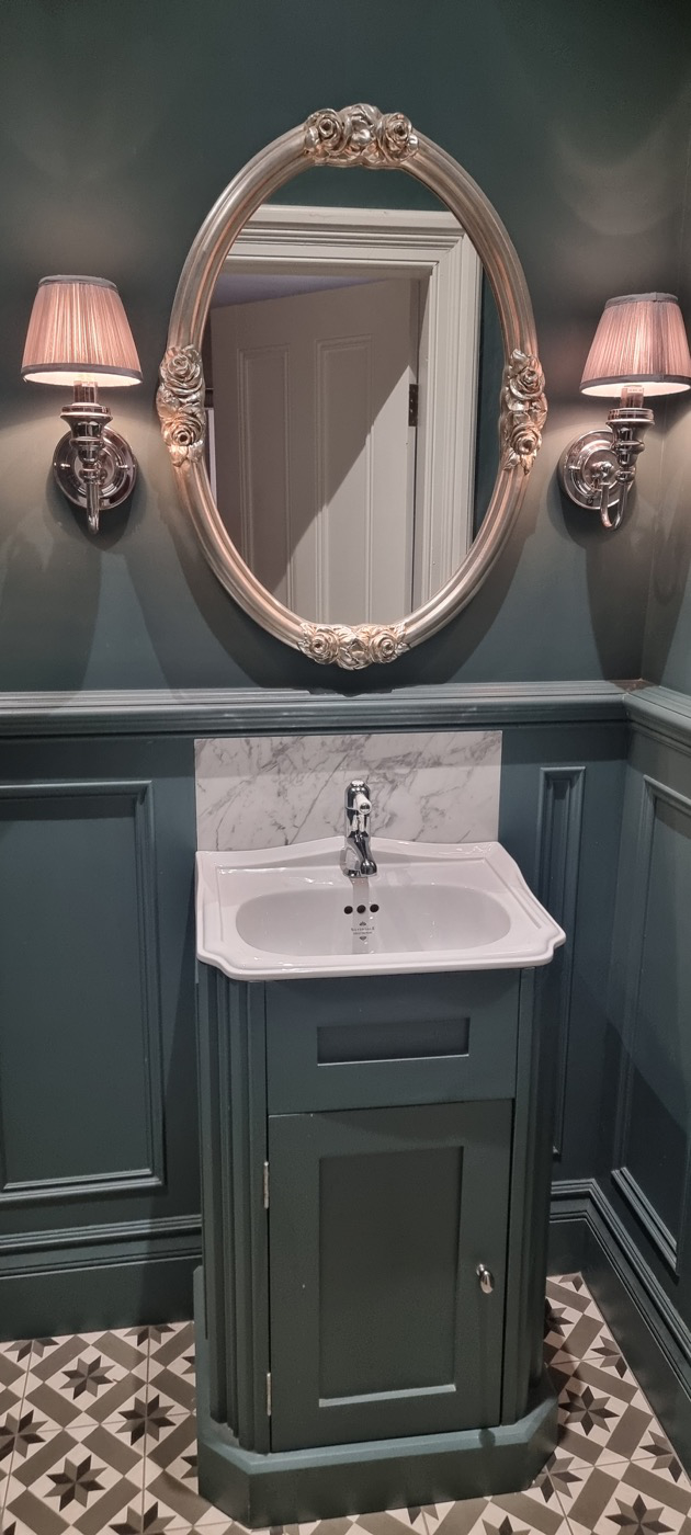 Finished Stockport downstairs toilet with Farrow and Ball Inchyra Blue panelling, fitted vanity and patterned flooring